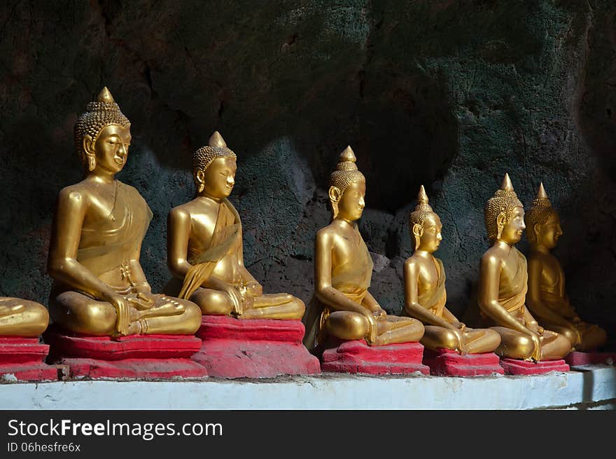 Six Sitting Golden Buddha in the caveg at Khao Luang Cave Temple in Petchaburi, Thailand. Six Sitting Golden Buddha in the caveg at Khao Luang Cave Temple in Petchaburi, Thailand