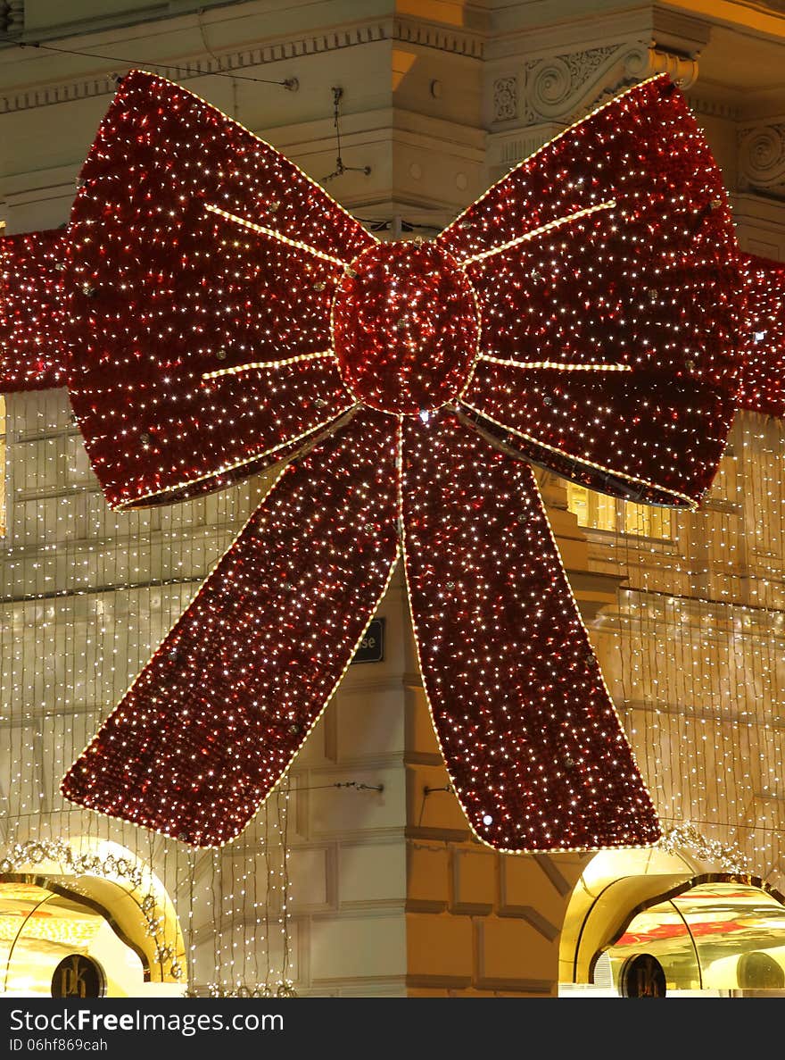 Christmas decoration over the entrance of an elegant sore in the city of vienna, austria. It shows a huge bow tie, all over covered with glittering lights. Christmas decoration over the entrance of an elegant sore in the city of vienna, austria. It shows a huge bow tie, all over covered with glittering lights