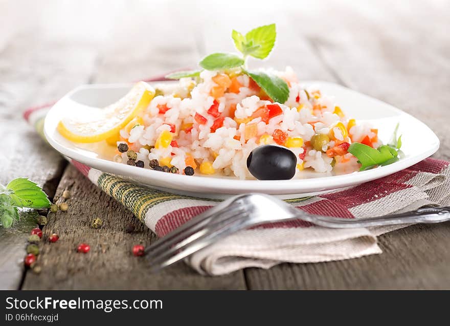 Rice with vegetables on a wooden table