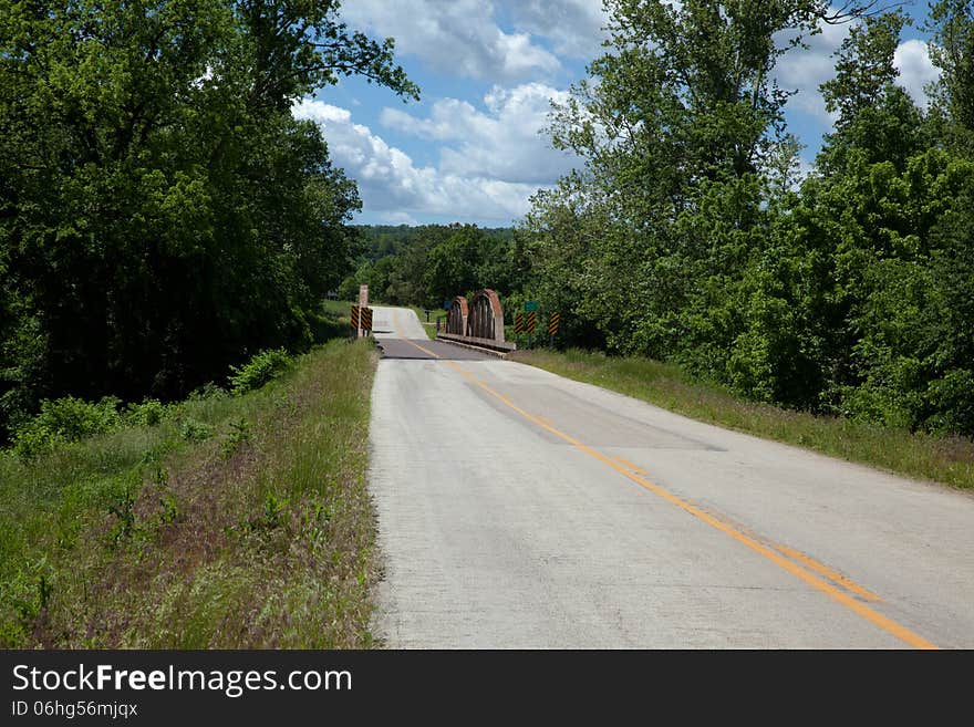 A country road with a bridge.