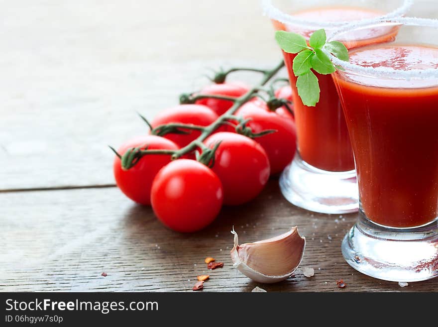 Sprig tomato, garlic and tomato juice on the table. Sprig tomato, garlic and tomato juice on the table