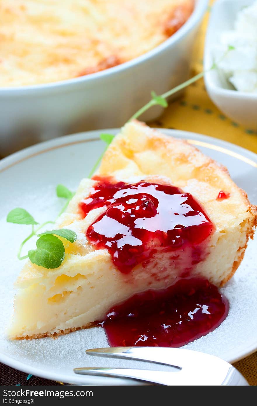 Piece of cheesecake with raspberry jam