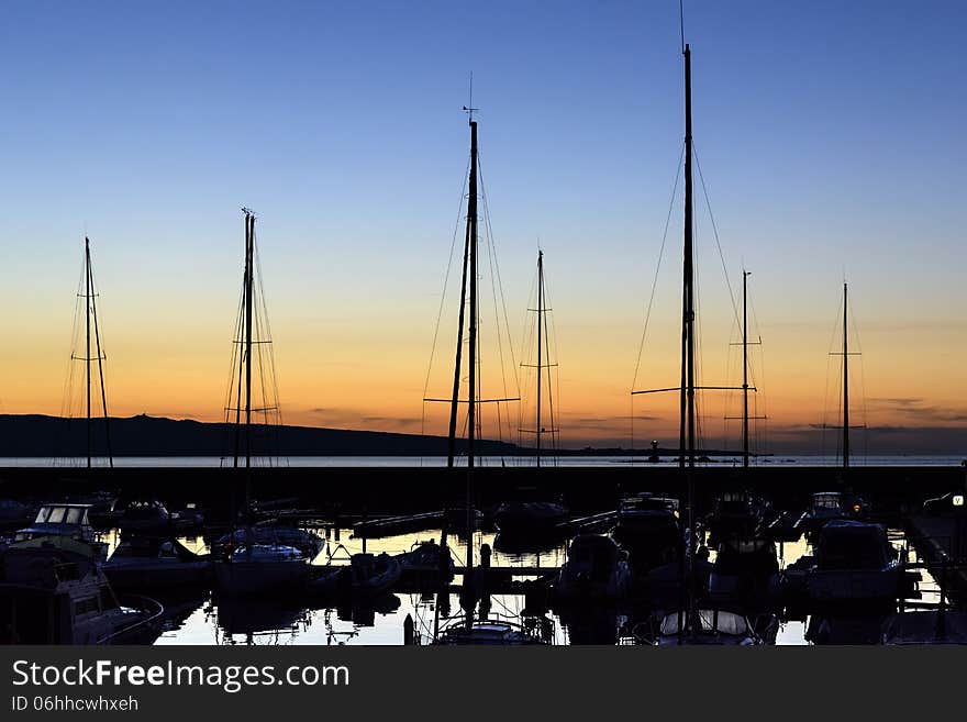 Sunset in the port of Portoscuso in the south west coast of Sardinia. Sunset in the port of Portoscuso in the south west coast of Sardinia.