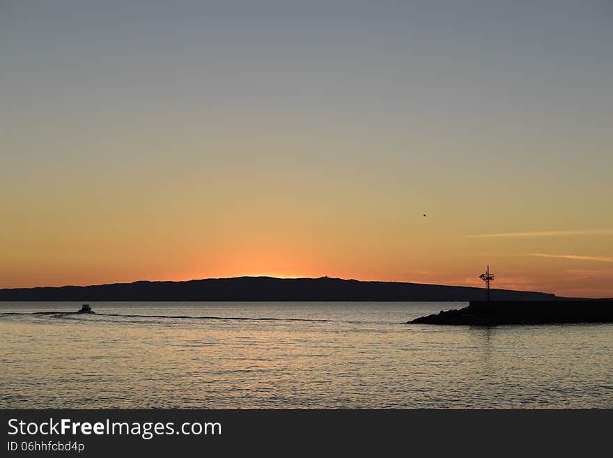 View of St. Peter at sunset. South west coast of Sardinia. View of St. Peter at sunset. South west coast of Sardinia.