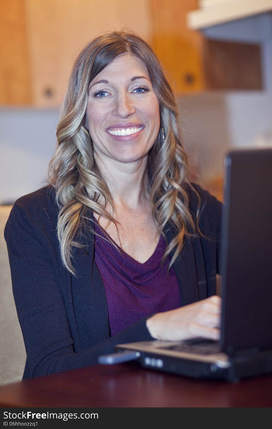 Proud Businesswoman At Home Office Using Laptop