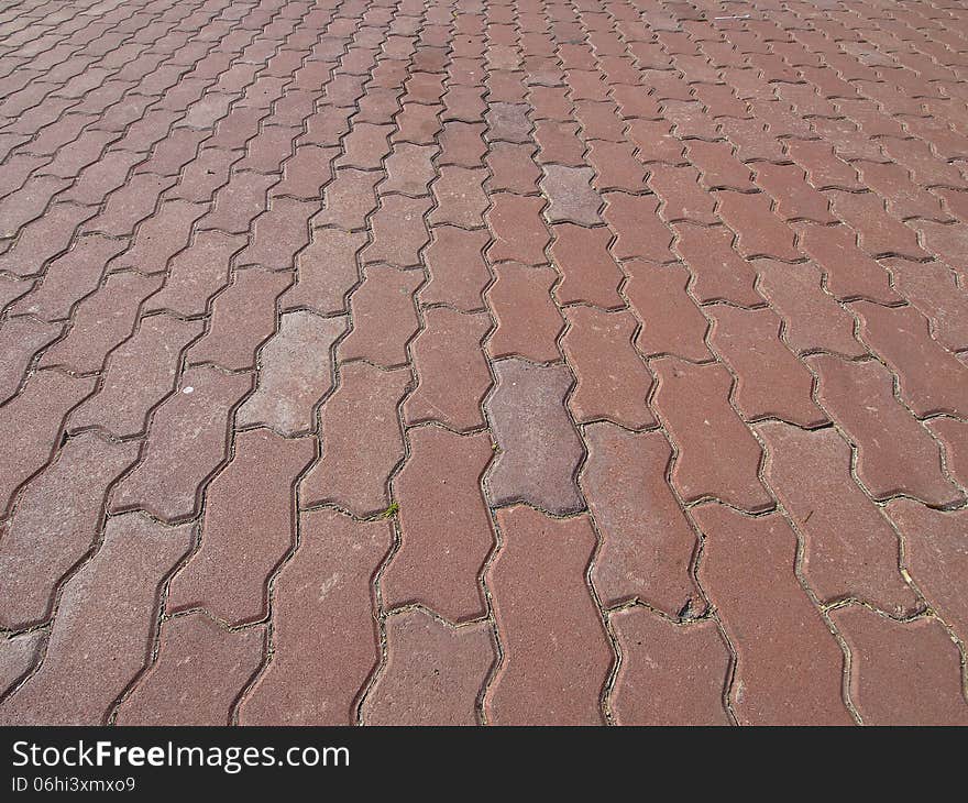 Perspective of red cobblestone floor of park in sunlight. Perspective of red cobblestone floor of park in sunlight