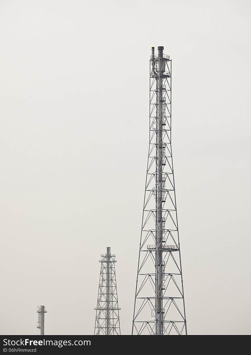 Group of high distillation tower in white sky. Group of high distillation tower in white sky