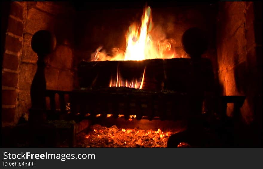 Warm, soothing fire in an old rustic fireplace. Warm, soothing fire in an old rustic fireplace.