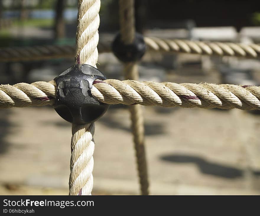 Closeup details of big rope in climb toy at playground in park. Closeup details of big rope in climb toy at playground in park