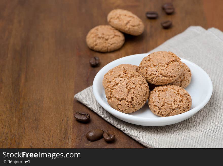 Biscotti cookies and coffee beans on a wooden table and space for text, horizontal