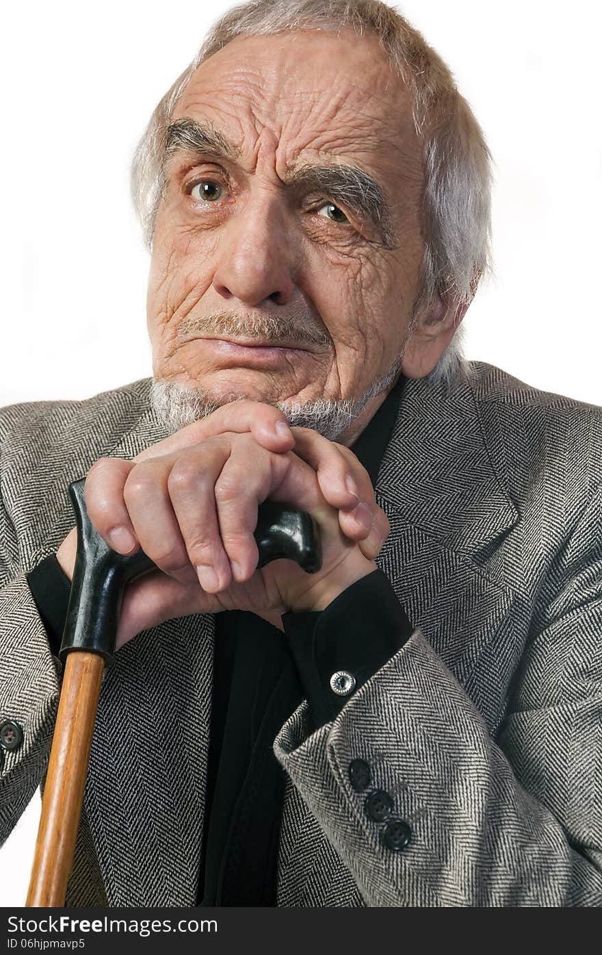 Portrait emotional elderly man leaning on a cane