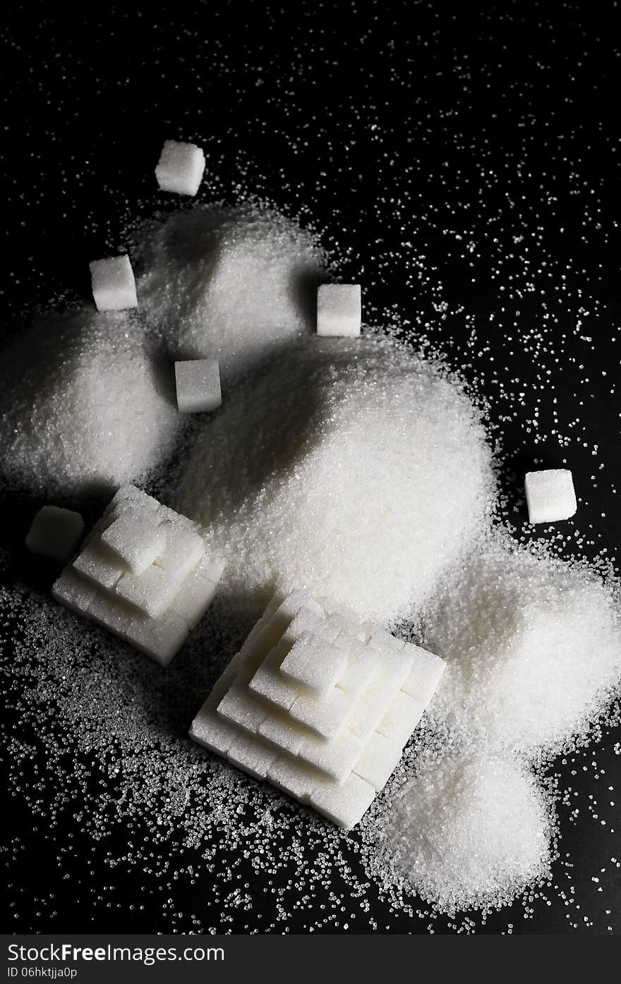 Refined white sugar on a black beckground