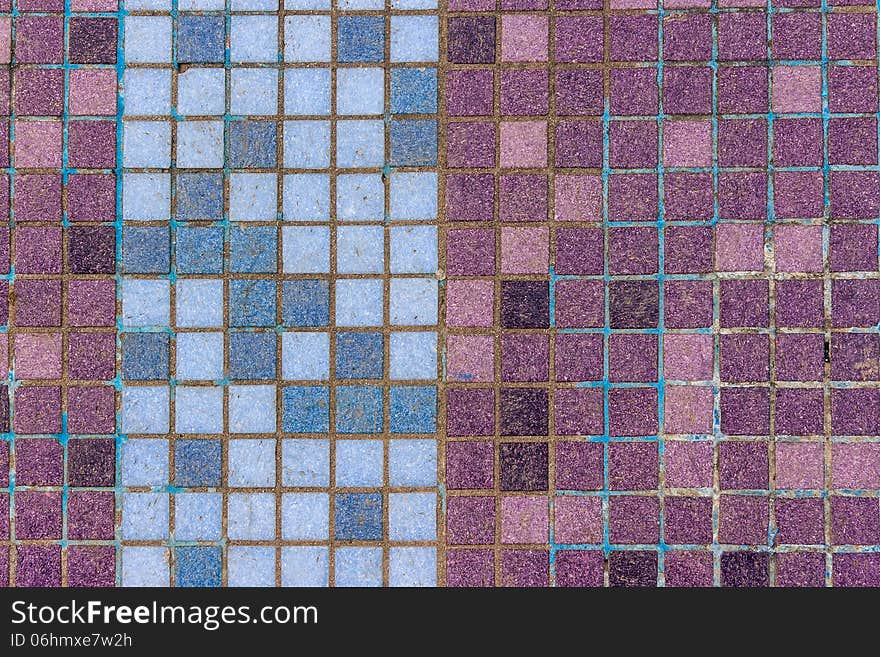 Old mosaic tiles of different colors lined in vertical blue pattern. Old mosaic tiles of different colors lined in vertical blue pattern