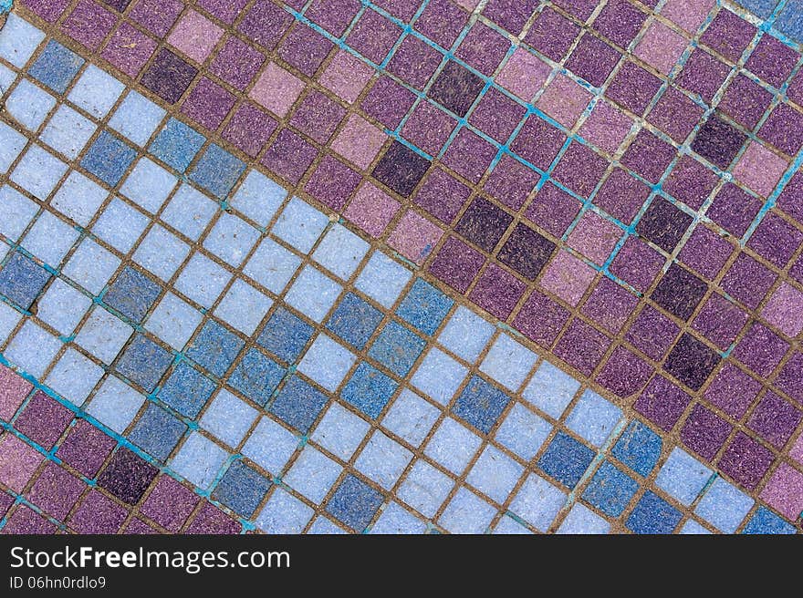 Old mosaic tiles of different shades lined  diagonal