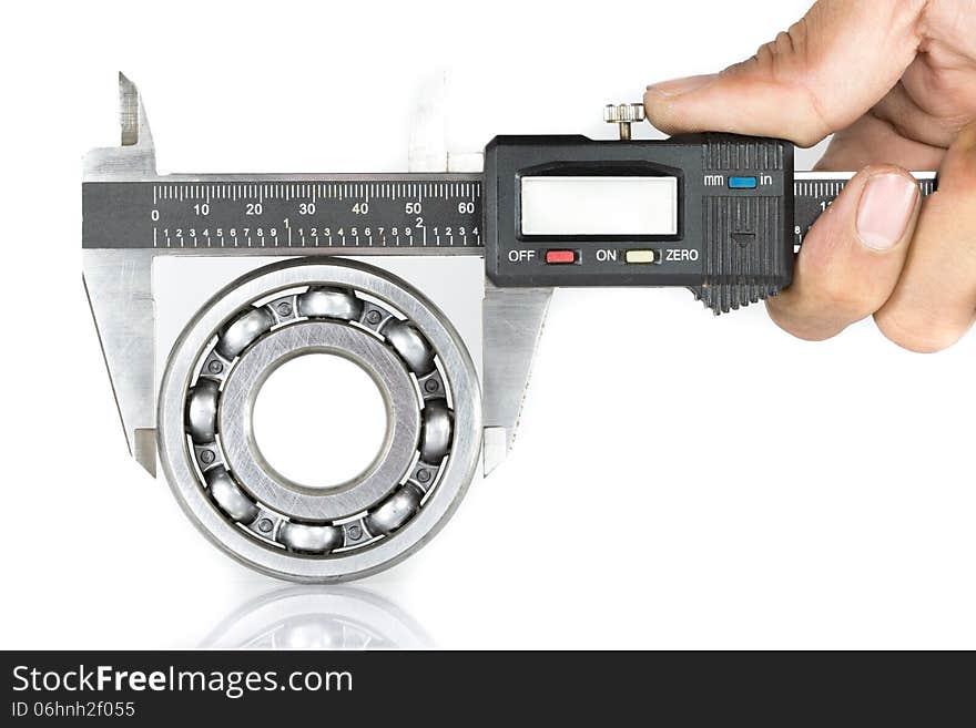 Metal vernier caliper and Ball bearings on white background. Metal vernier caliper and Ball bearings on white background