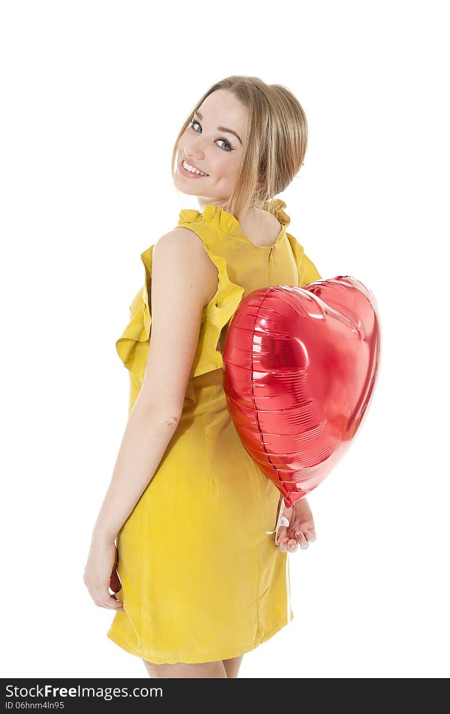 Woman holding red heart balloon.