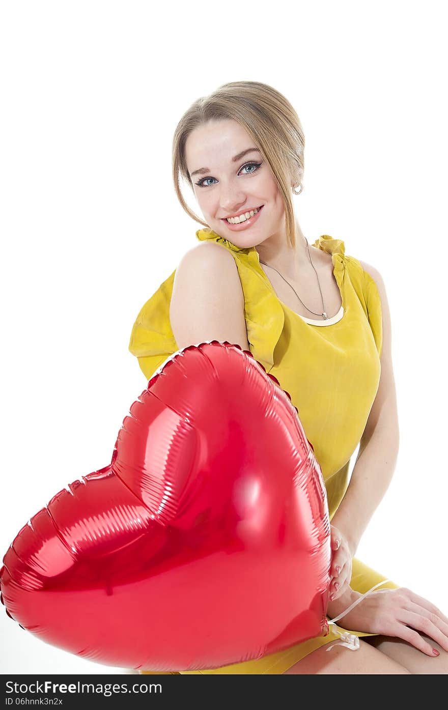 Smiling woman with red heart balloon on white background