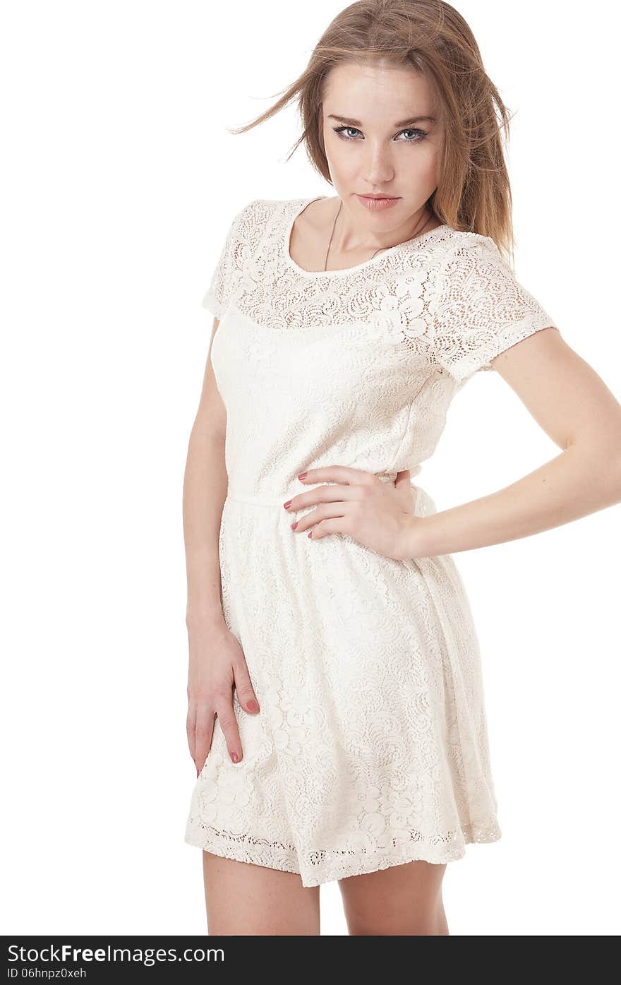 Seductive young girl dressed in a short white dress, isolated on white background.