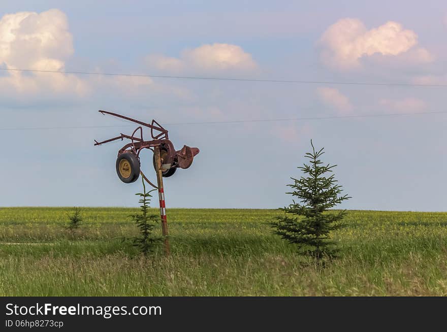 Antique plow on a post