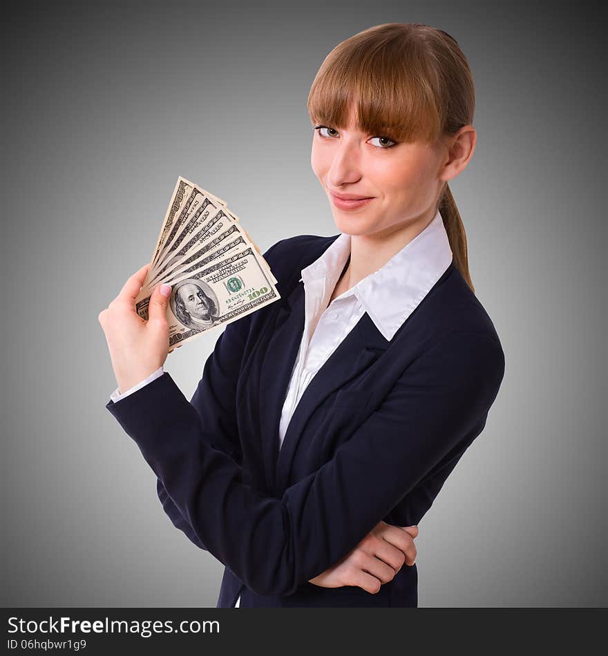 Happy business woman holding cash dollars in the hands of welcoming smile. The concept of finance success. Isolated, space for text