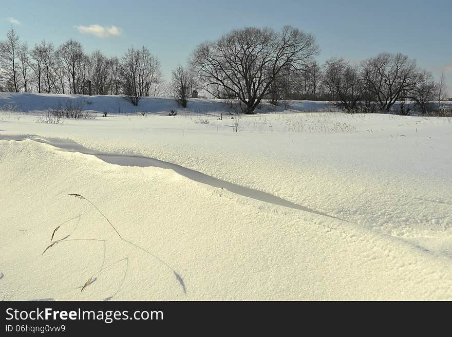 Winter Landscape in Sunlight with long shadow. Volkhov River. Russia.