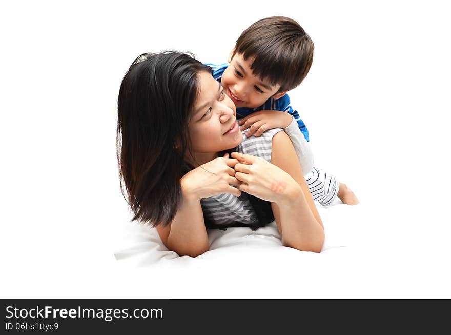 Mother And Son Lying In Bed Together