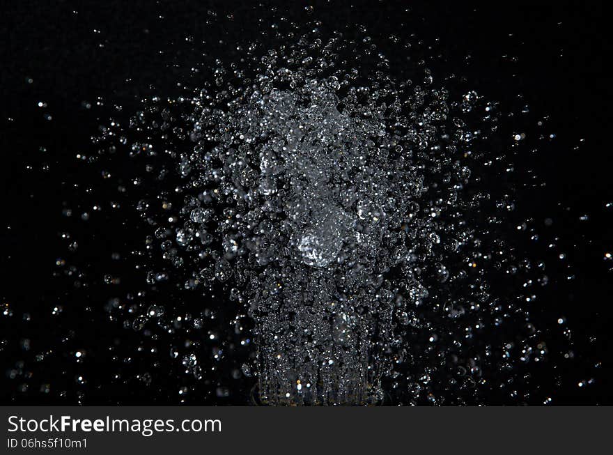 The photo shows a bunch of water drops on a black background. The photo shows a bunch of water drops on a black background