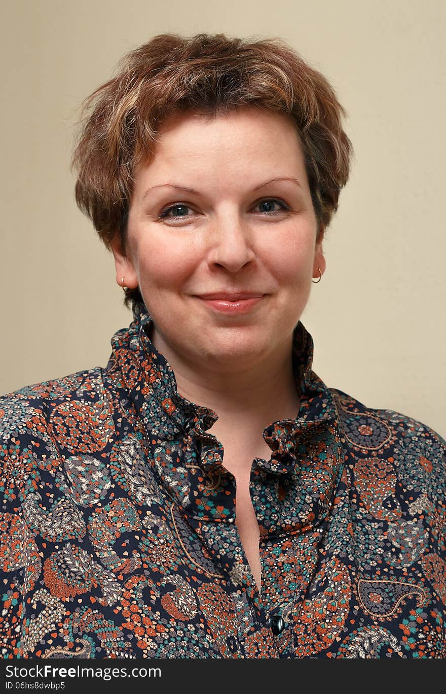 Portrait of the adult woman on a beige background. Portrait of the adult woman on a beige background.