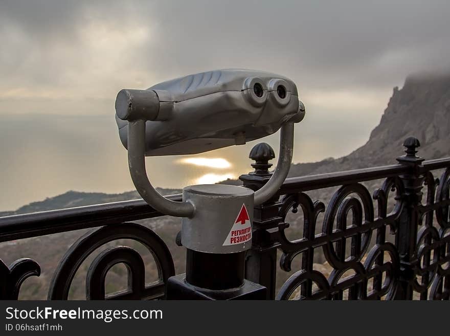 Binoculars telescope looking Foros panorama from the observation point of Christ's resurrection church