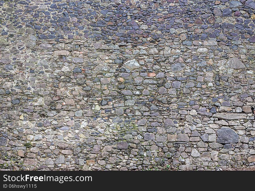 Wall of the sharp stones of various sizes