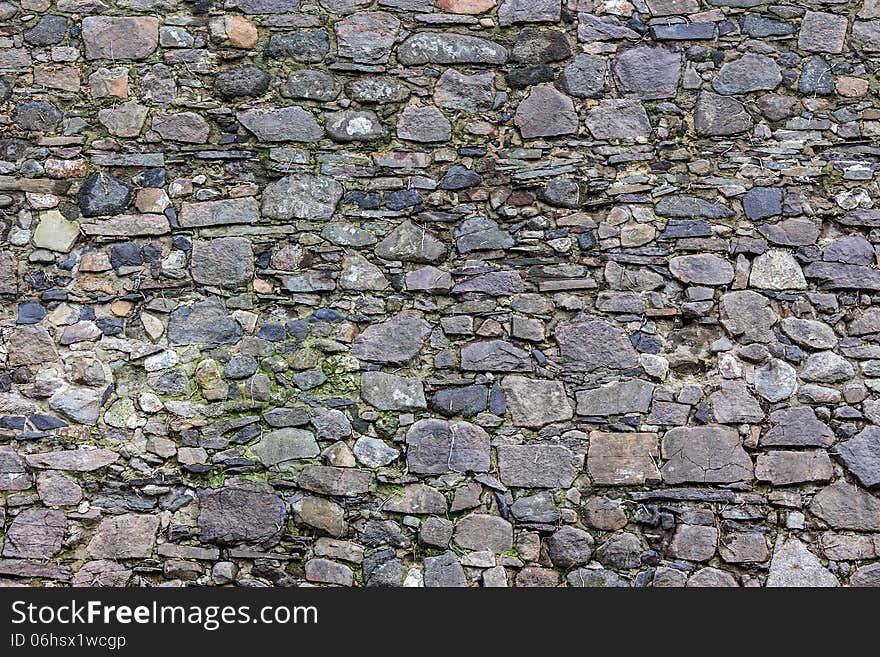 Wall of the sharp stones of various sizes