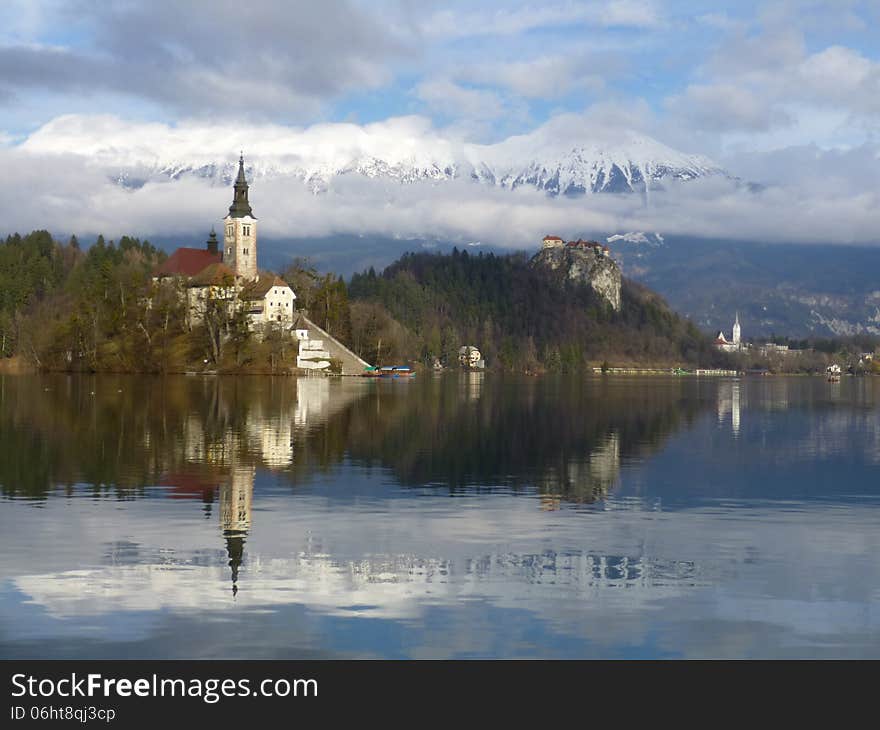 Island at the Lake of Bled with a Castle behind. Island at the Lake of Bled with a Castle behind