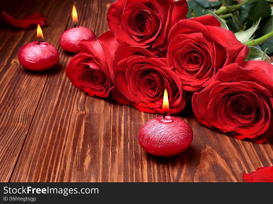 Romantic composition with red candles and roses. selective focus