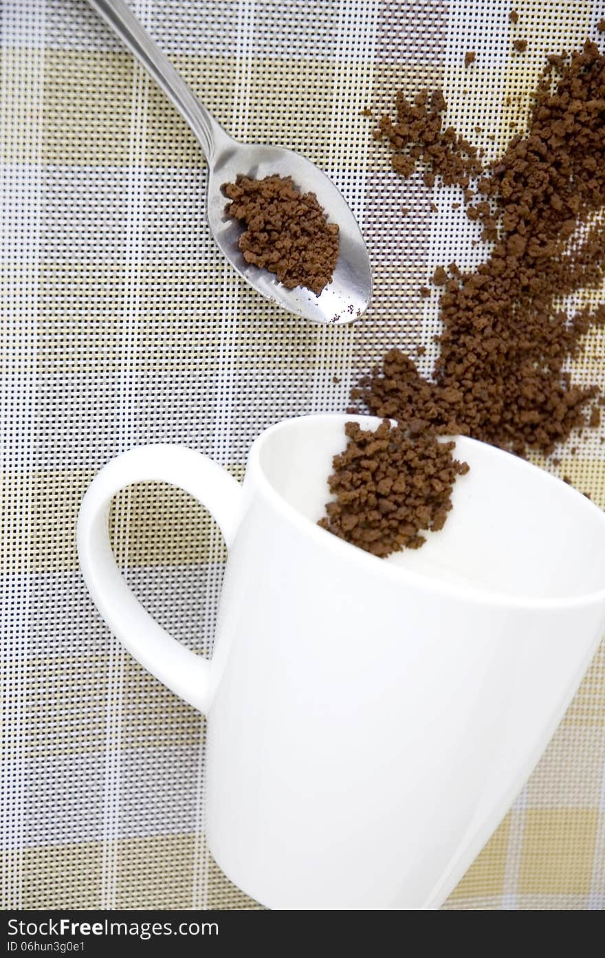 Coffee in spoon and cup