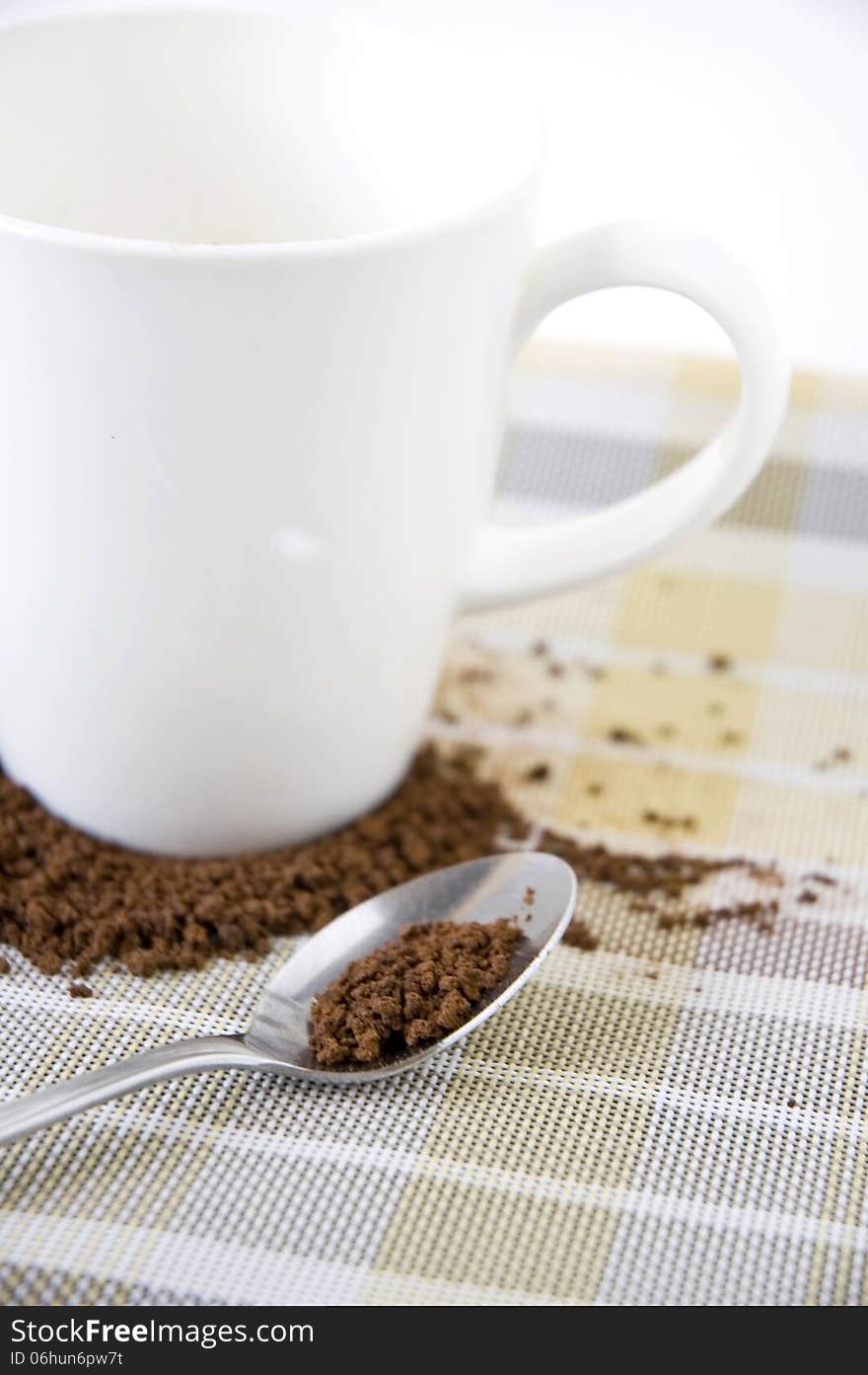 Coffee in spoon with white cup