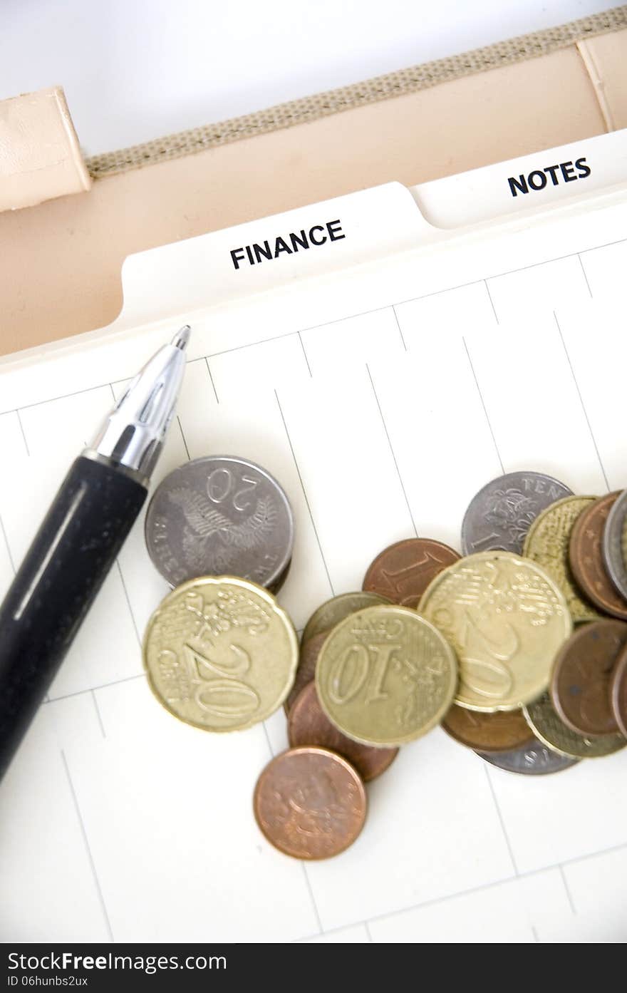 Euro Coins With Pen On Finance Page