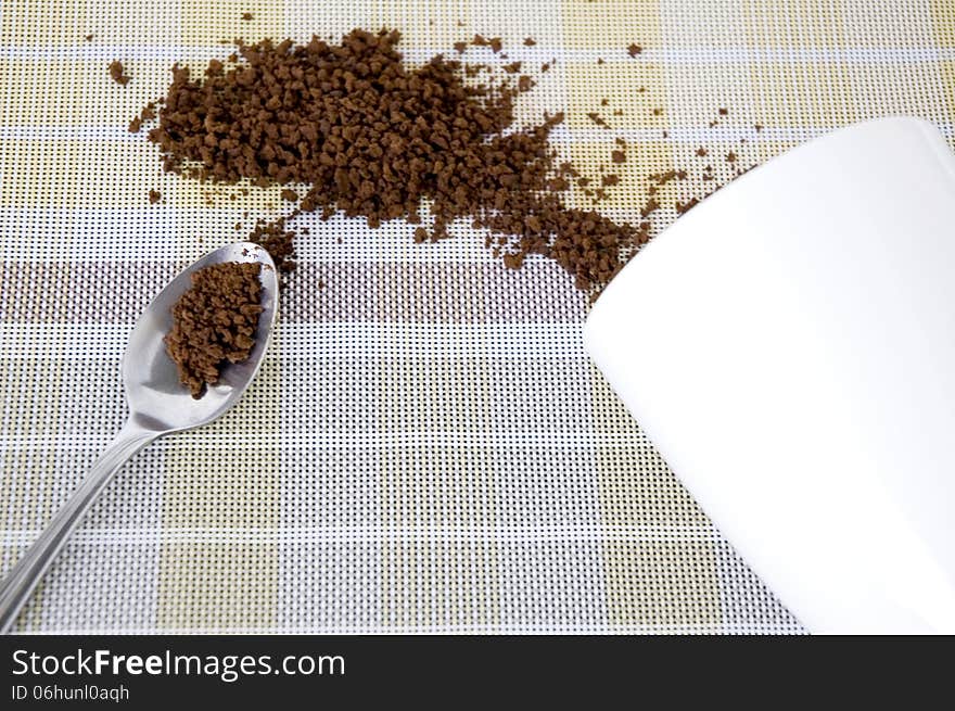 Instant coffee in spoon and out of cup