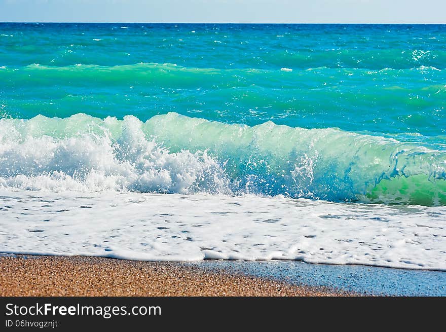 Strong foaming waves and beach