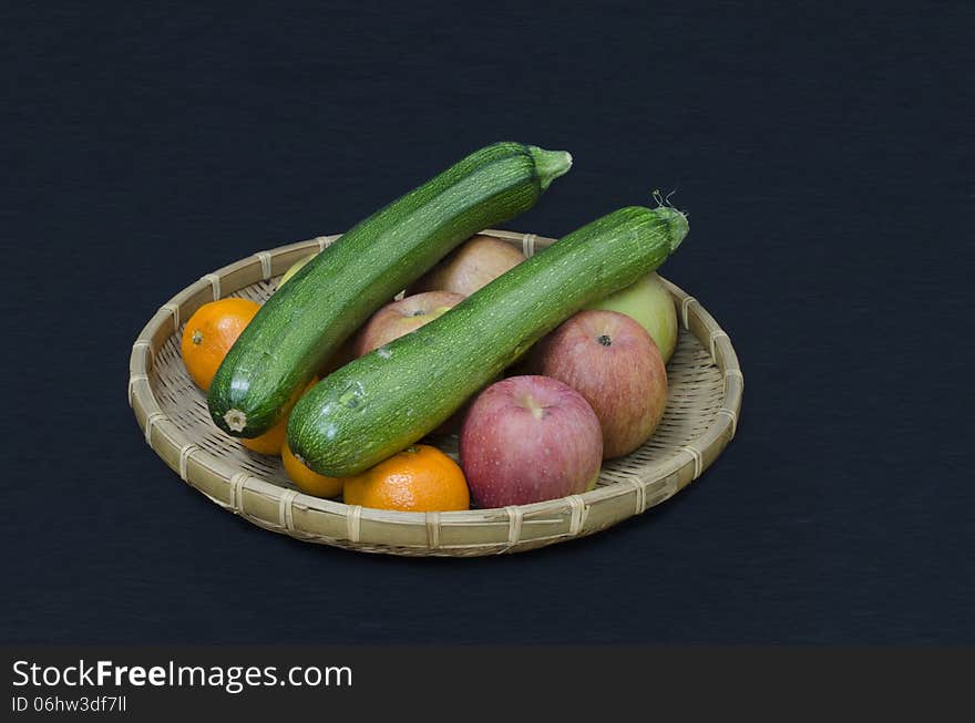 Fruit and zucchini in a rattan bowl. Fruit and zucchini in a rattan bowl.