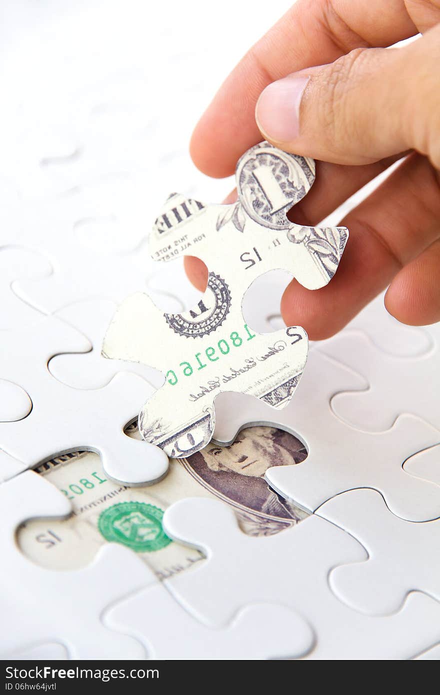 Hand holding a puzzle piece, Finance concept