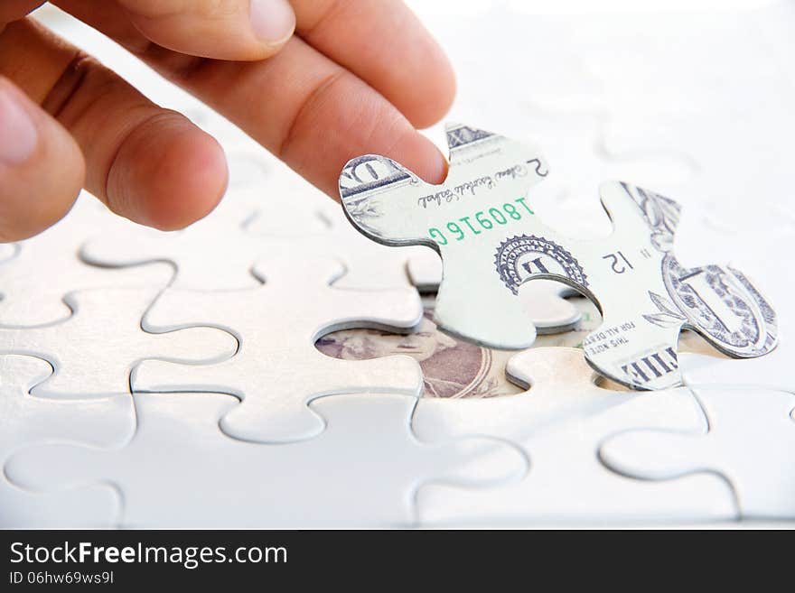 Hand holding a puzzle piece, Finance concept