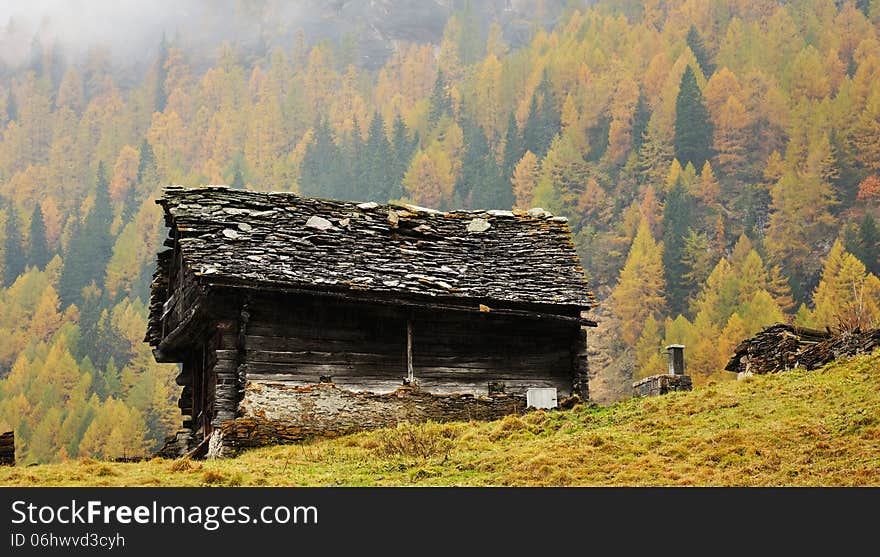 typical mountain hut in autumn landscape in Italy Alps. typical mountain hut in autumn landscape in Italy Alps