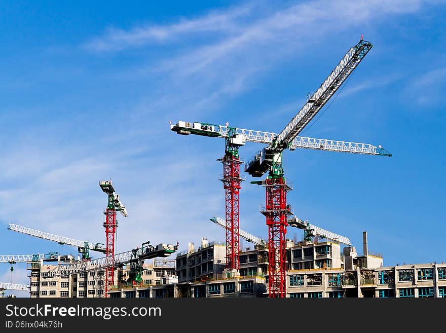 Cranes at construction site in Singapore.