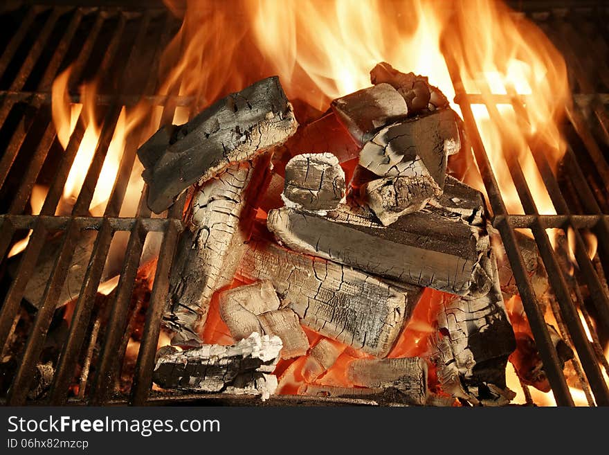 Glowing charcoal and flames in barbecue grill XXXL