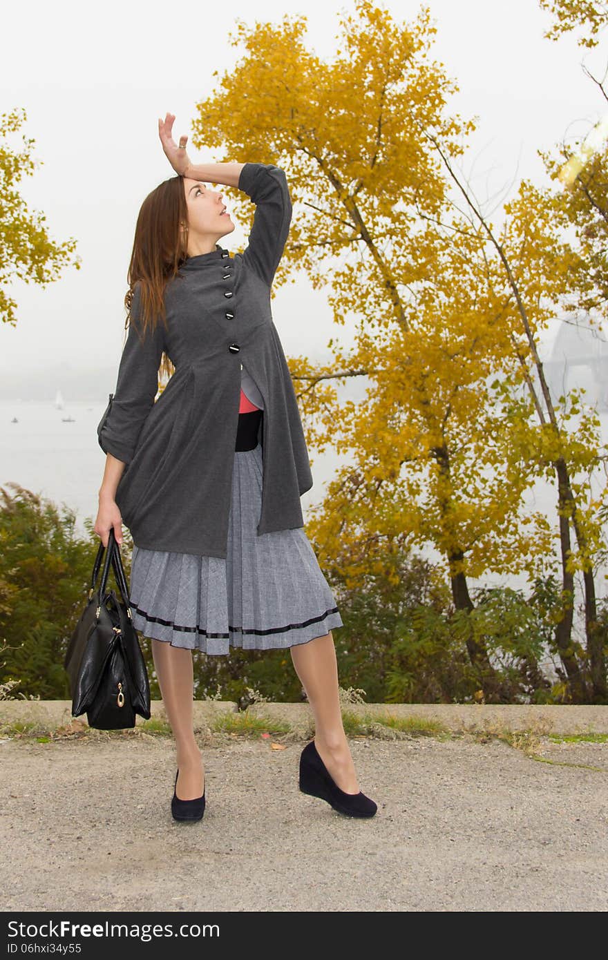 Fashionable young woman with hand bag - outdoor.