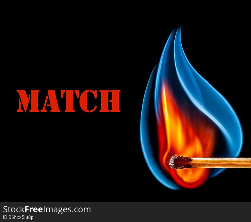 Wooden match is burning on black background