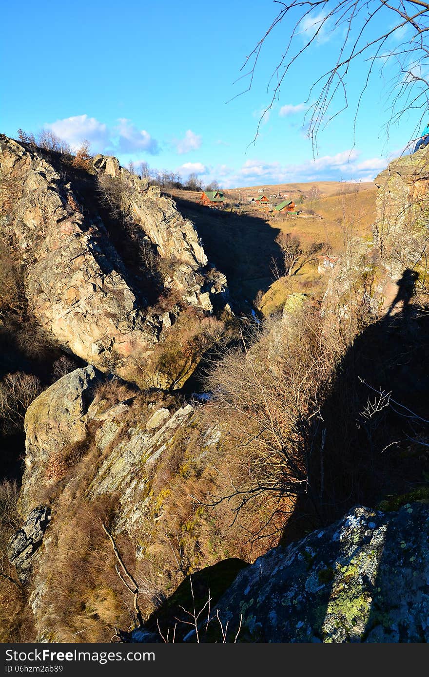 Landscape with blue sky, gorge and shadow of the p