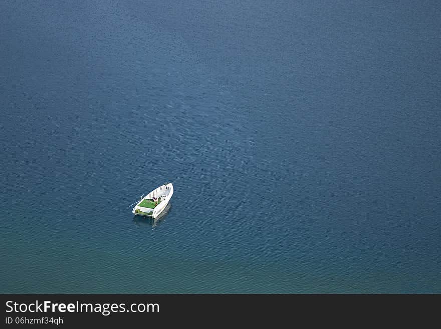 A white boat in blue waters. A white boat in blue waters