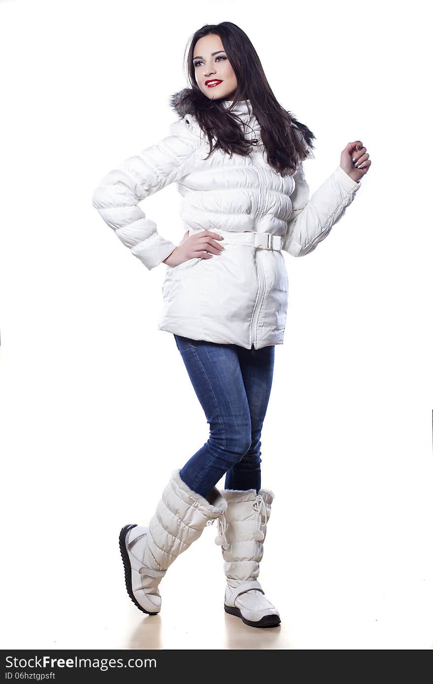 Pretty girl in winter clothes posing on white background. Pretty girl in winter clothes posing on white background