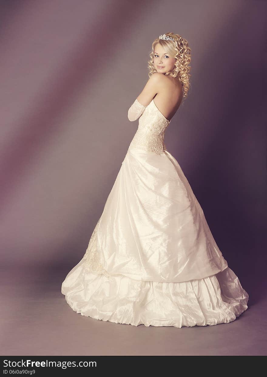 Bride over gray background, studio shot.